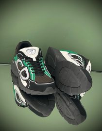 Dior B30 sneakers in black, green, and white with mesh and leather panels, featuring the bold .