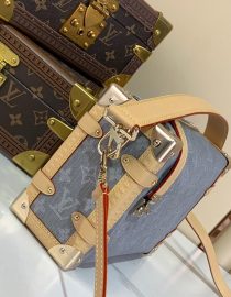 A compact Louis Vuitton trunk-style bag in denim canvas with monogram pattern, natural leather trim, and silver-tone hardware.
