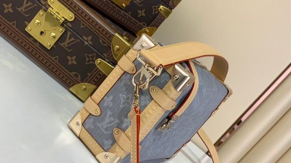 A compact Louis Vuitton trunk-style bag in denim canvas with monogram pattern, natural leather trim, and silver-tone hardware.