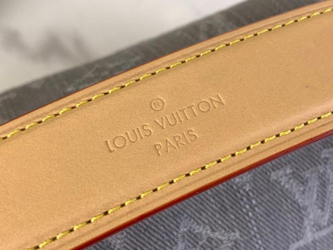 A compact Louis Vuitton trunk-style bag in denim canvas with monogram pattern, natural leather trim, and silver-tone hardware.